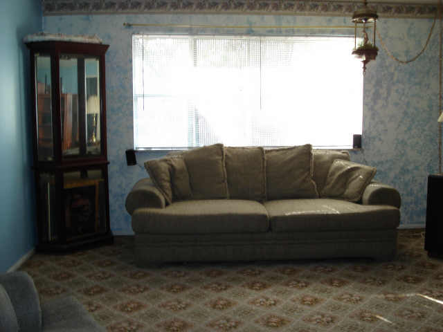 bird border house wallpaper. The living room features an oil lamp, wallpaper border, pale blue sponge 