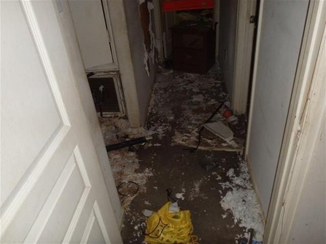 junk stuff garbage insulation everywhere on floor hallway fixer-upper Houston Texas home house for sale photo