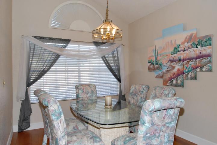 80s décor Southwest artwork pastel color dining chairs brass light Phoenix home house