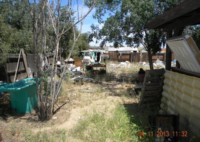 ugly back yard piles of junk garbage hoarding fixer-upper short sale Peoria Arizona home house real estate photo