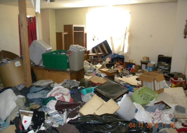 ugly family room hoard piles of junk dirty fixer-upper short sale Peoria Arizona home house real estate photo