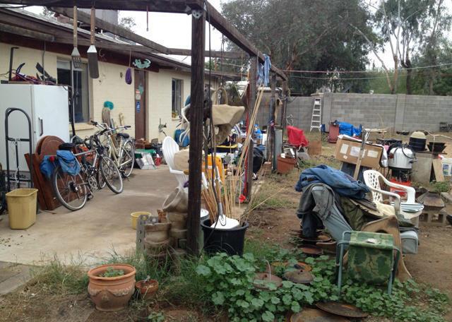 messy cluttered stuff junk everywhere back yard patio fixer-upper neglected Phoenix Arizona home house for sale photo