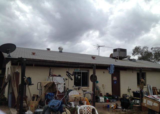 messy cluttered stuff junk everywhere back yard patio fixer-upper neglected Phoenix Arizona home house for sale photo