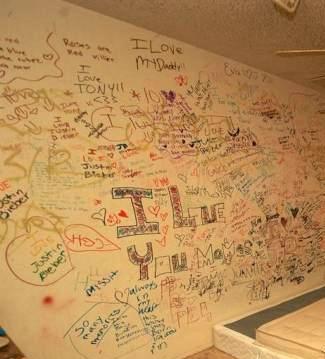 graffiti I love Justin Bieber written on bedroom wall cluttered messy poor bad home staging Mesa Arizona house for sale