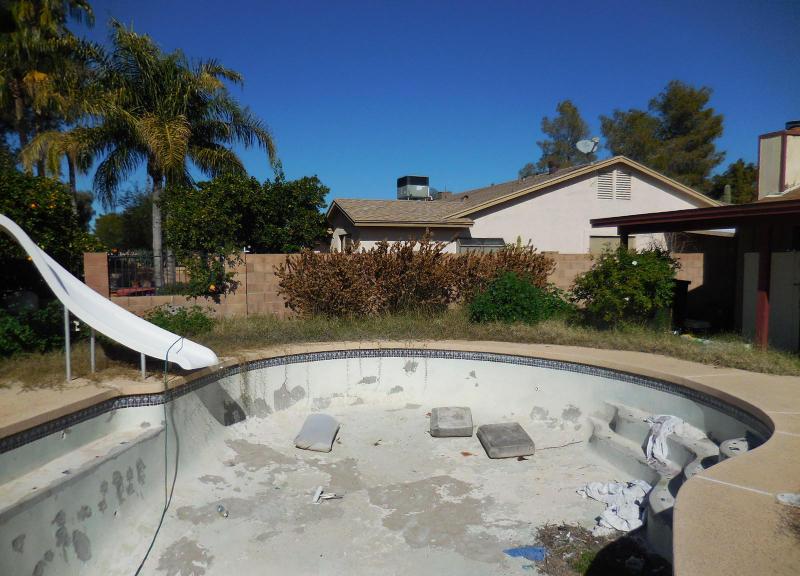 neglected damaged swimming pool with green algae water fixer-upper Mesa Arizona home house for sale photo