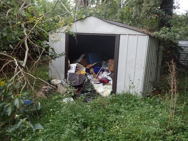 almost filled up storage shed junk garbage stuff back yard fixer-upper Houston Texas home house for sale photo