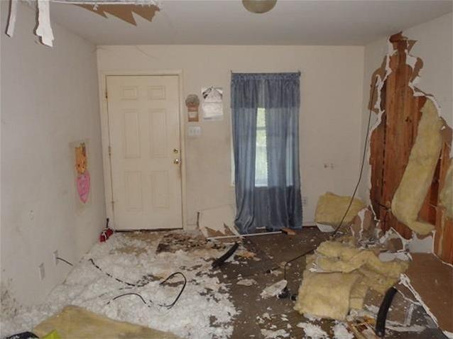 white insulation everywhere damaged drywall wall hole fixer-upper Houston Texas home house for sale photo