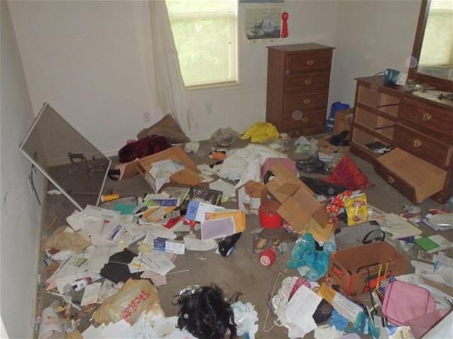 junk stuff garbage everywhere on floor bedroom clutter chaotic fixer-upper Houston Texas home house for sale photo