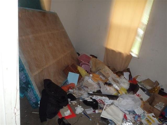 junk stuff garbage everywhere on floor bedroom clutter chaotic fixer-upper Houston Texas home house for sale photo