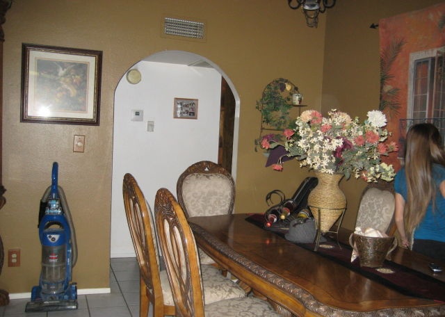 little girl vacuum fake flowers dining room Mesa Arizona home house for sale real estate photo