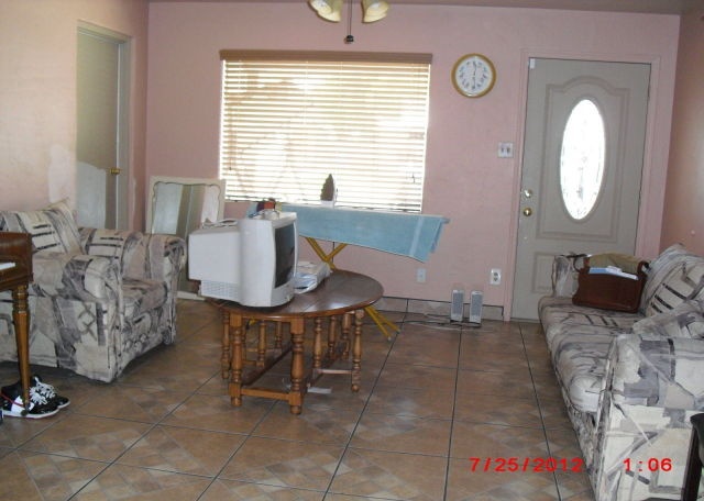 cluttered living room poor bad home staging ironing board Phoenix Arizona house for sale