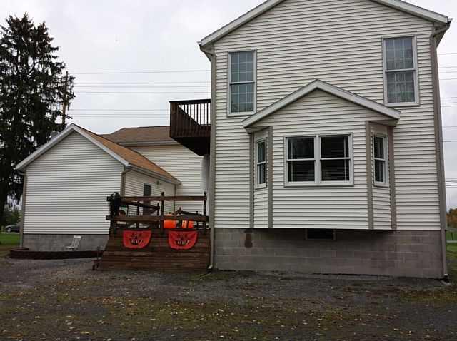 Halloween pumpkin decorations in front Penfield New York home house for sale real estate photo