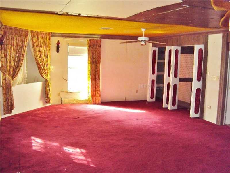 outdated ugly décor red carpet bedroom drapes damaged ceiling Dade City Florida home house for sale photo