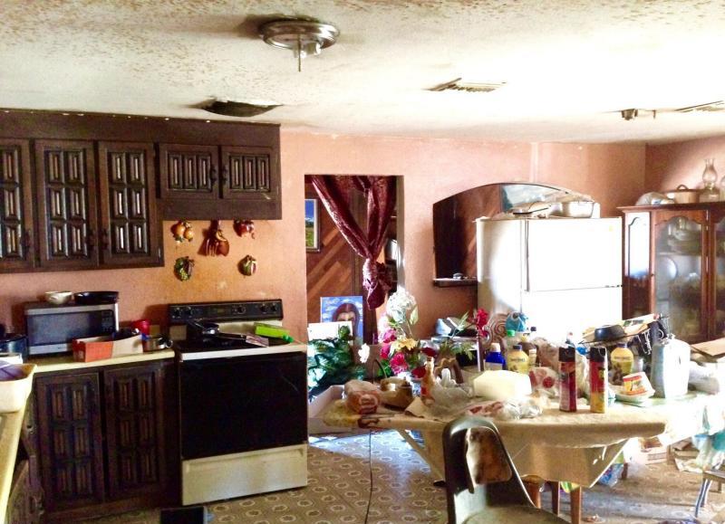 messy cluttered junky neglected kitchen ugly John F. Long cabinets knotted curtain two cans of Raid bug spray dirty fixer-upper Phoenix Arizona homes houses for sale photo
