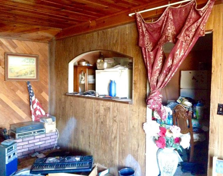 messy cluttered junky neglected family room damaged knotted curtain dirty fixer-upper Phoenix Arizona homes houses for sale photo