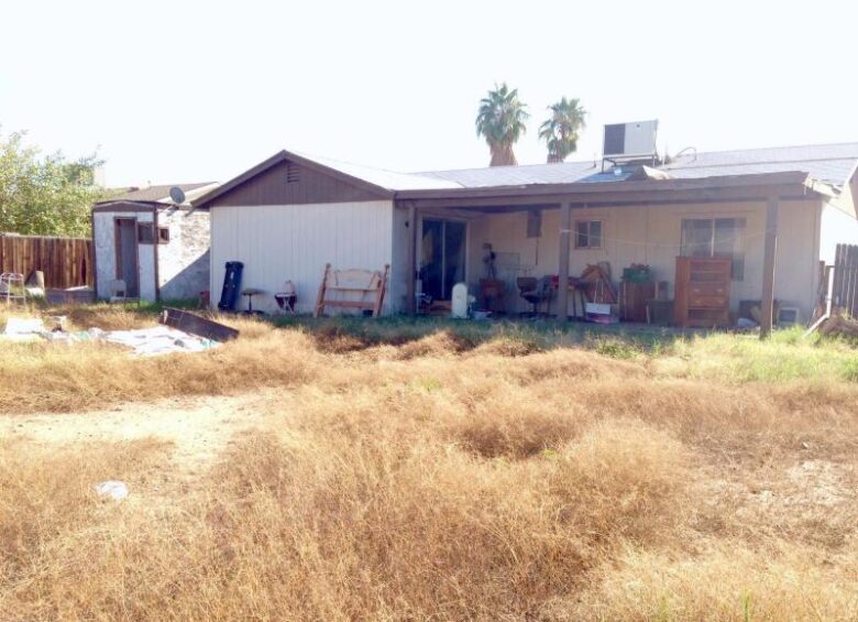 back yard dead weeds patio clutter neglected fixer-upper Phoenix Arizona homes houses for sale photo