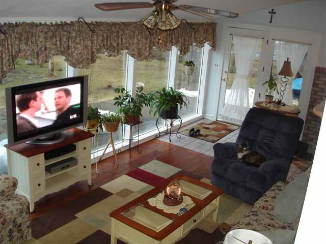ugly flowery curtains sunroom big widescreen TV tacky décor New York home house