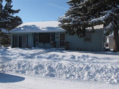 heavy snow front yard curb appeal outdated real estate photo Mason City Iowa home for sale