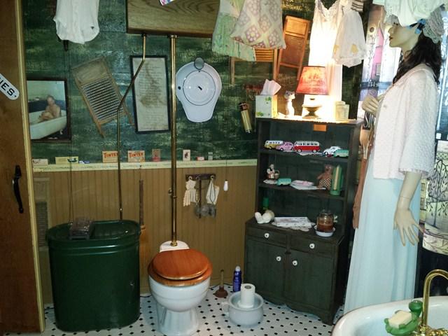 lady mannequin bedpan old toilet cluttered bathroom Penfield New York home house for sale real estate photo