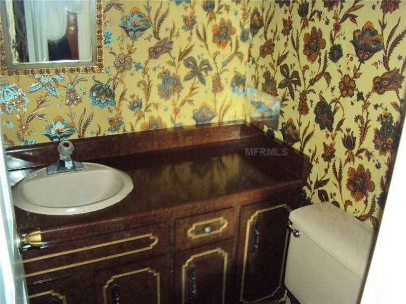 outdated ugly décor floral wallpaper bathroom vanity Dade City Florida home house for sale photo