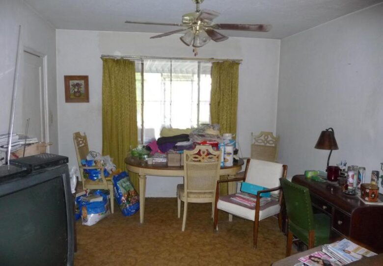 cluttered messy disorganized boxes dining room dog food dusty ceiling fan blades too much stuff poor bad home staging Phoenix Arizona house for sale