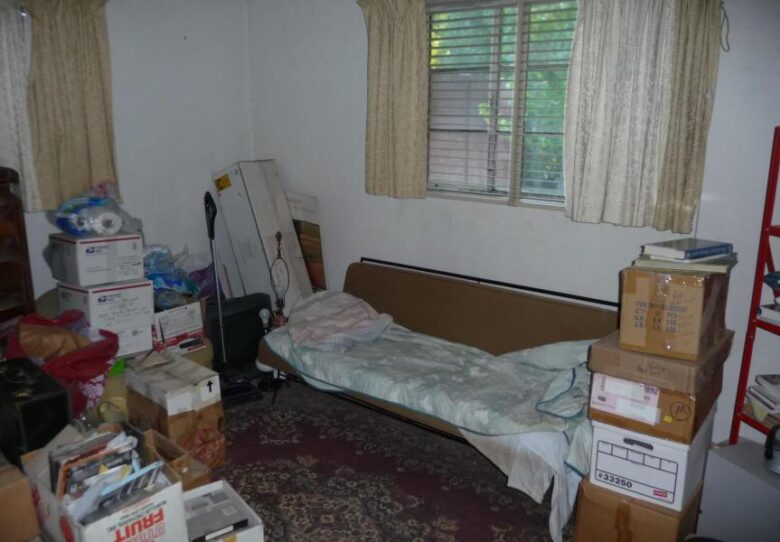 cluttered messy disorganized boxes bedroom too much stuff poor bad home staging Phoenix Arizona house for sale photo