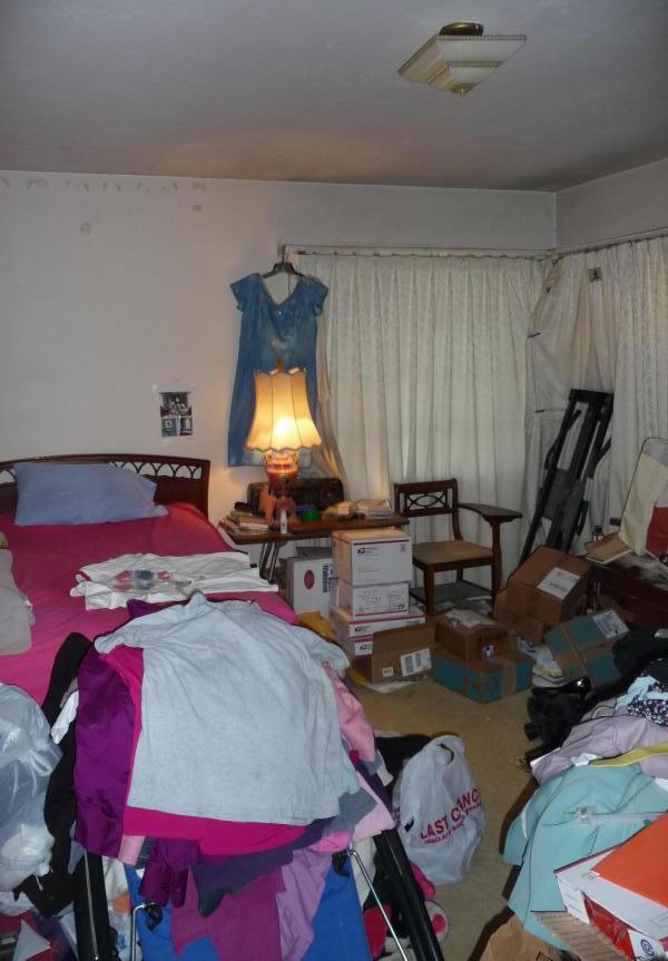 cluttered messy disorganized boxes bedroom bags too much stuff poor bad home staging Phoenix Arizona house for sale photo