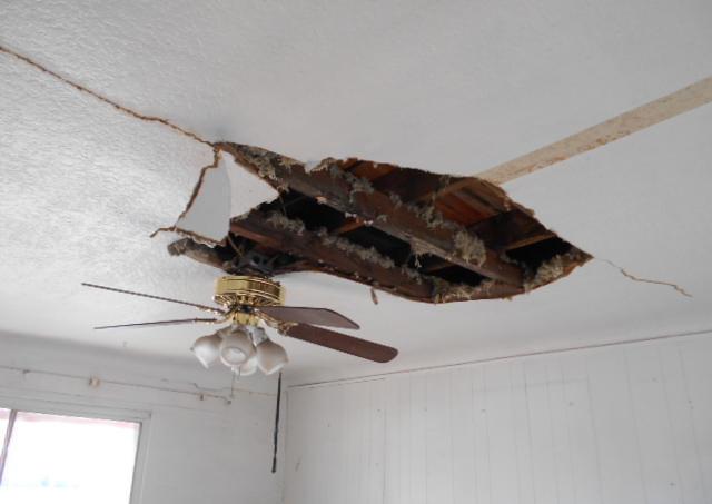 damaged big hole in ceiling exposed rafters attic fixer-upper Mesa Arizona homes houses for sale real estate photo