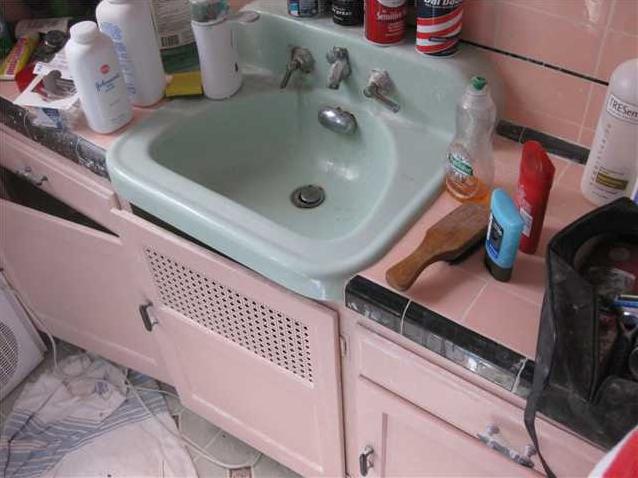 cluttered messy disorganized bathroom toiletries on counter San Diego California home house for sale real estate photo