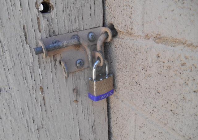close-up view shot photo picture of Barlock padlock peeling paint gate lock Phoenix Arizona homes houses for sale real estate