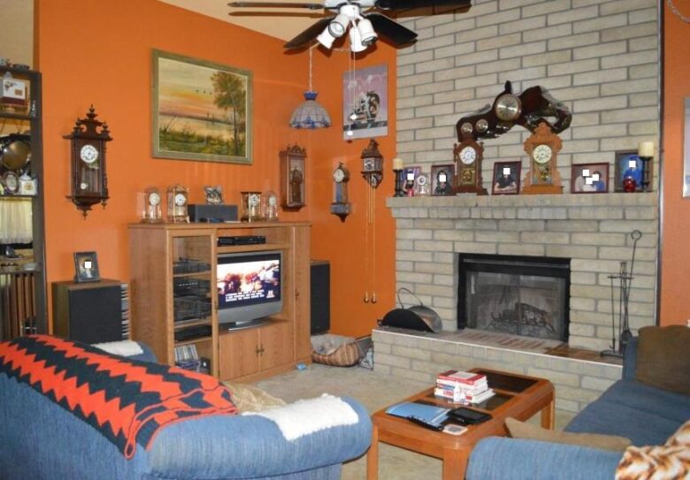 clock collection family photos TV is on Mesa Arizona homes houses for sale staging real estate photo orange wall