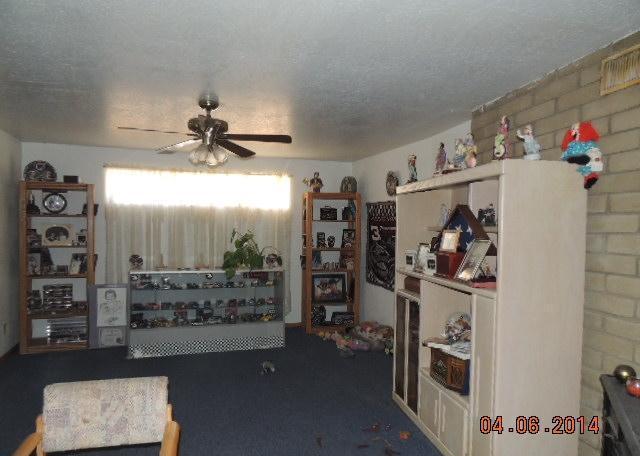 cluttered messy chaotic disorganized family room poor bad home staging clowns Apache Junction Arizona house for sale photo