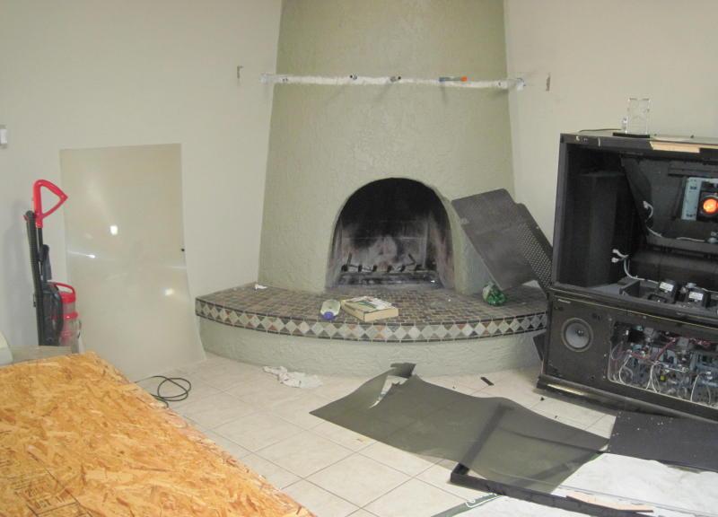 large TV television set broken apart opened up damaged ruined fireplace vacuum cleaner Glendale Arizona home house for sale photo