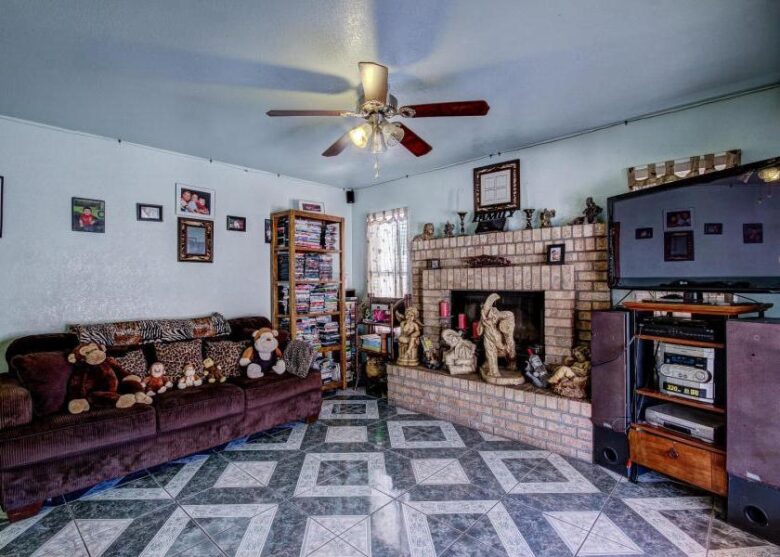 ugly floor tile pattern cluttered family room too much stuff statues poor bad home staging Phoenix Arizona house for sale