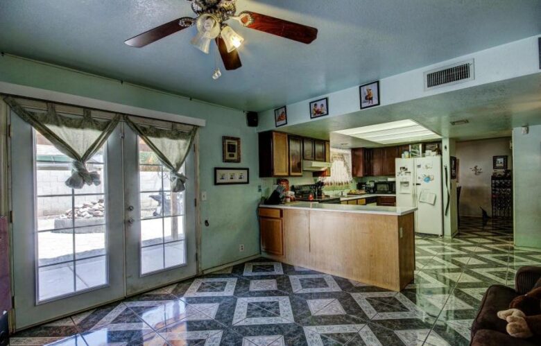 ugly floor tile pattern cluttered family room too much stuff poor bad home staging Phoenix Arizona house for sale knotted curtains
