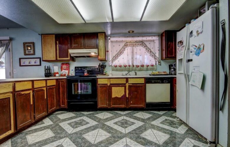 ugly floor tile pattern kitchen cabinets peeling paint lacquer finish missing Phoenix Arizona house for sale belt on wall