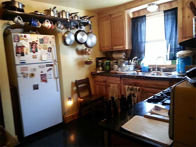 cluttered kitchen pots pans refrigerator magnets Grove City Pennsylvania home house for sale photo