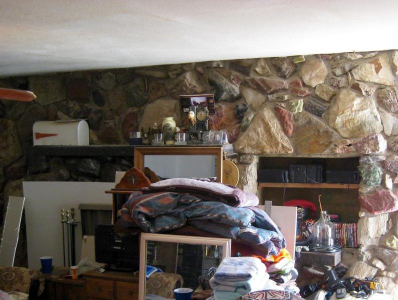 fireplace hidden behind piles of clutter belongings mailbox Apache Junction Arizona home house for sale photo