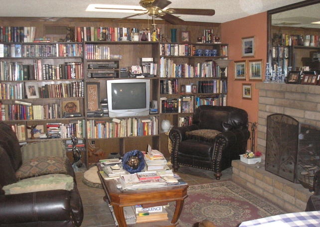 cluttered family room too many books drab boring dusty dull Mesa Arizona poor bad home staging house