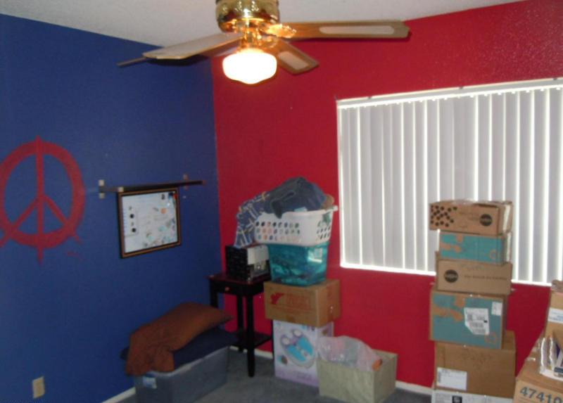 peace sign painted on wall cluttered bedroom boxes piled Mesa Arizona home house for sale real estate photo