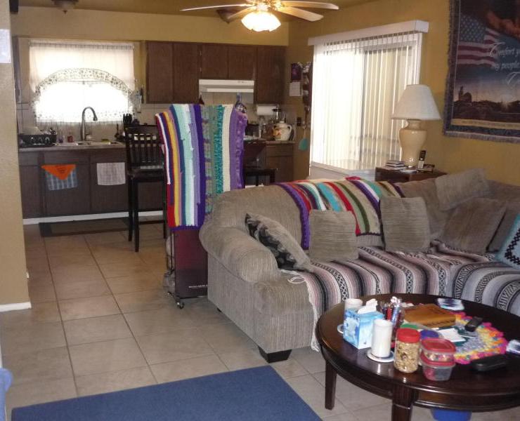 cluttered living room Afghan blankets poor home staging Glendale Arizona house for sale real estate photo
