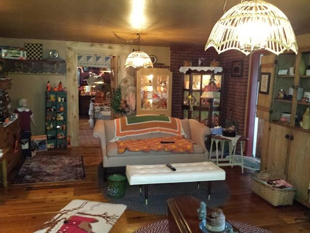 cluttered family room girl mannequin staging nightmare Penfield New York home house for sale real estate photo