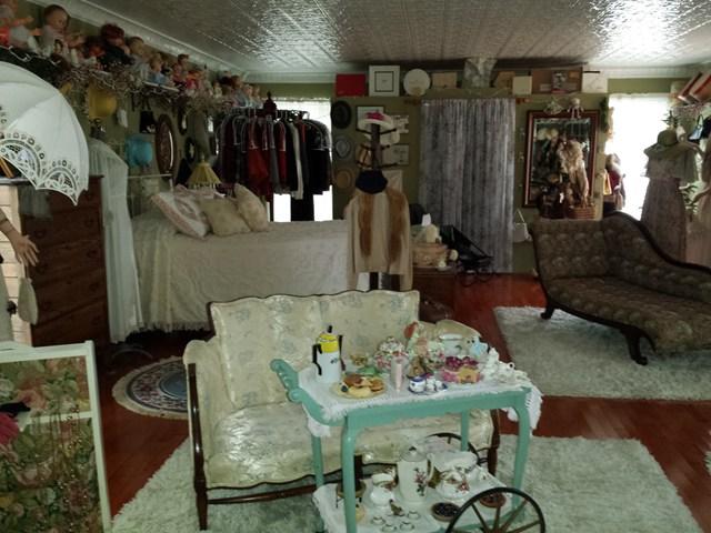 cluttered room collection mannequin clothes hats tea set staging nightmare Penfield New York home house for sale