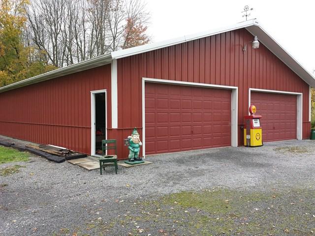 gnome statue old gas pump in front garage Penfield New York home house for sale real estate photo